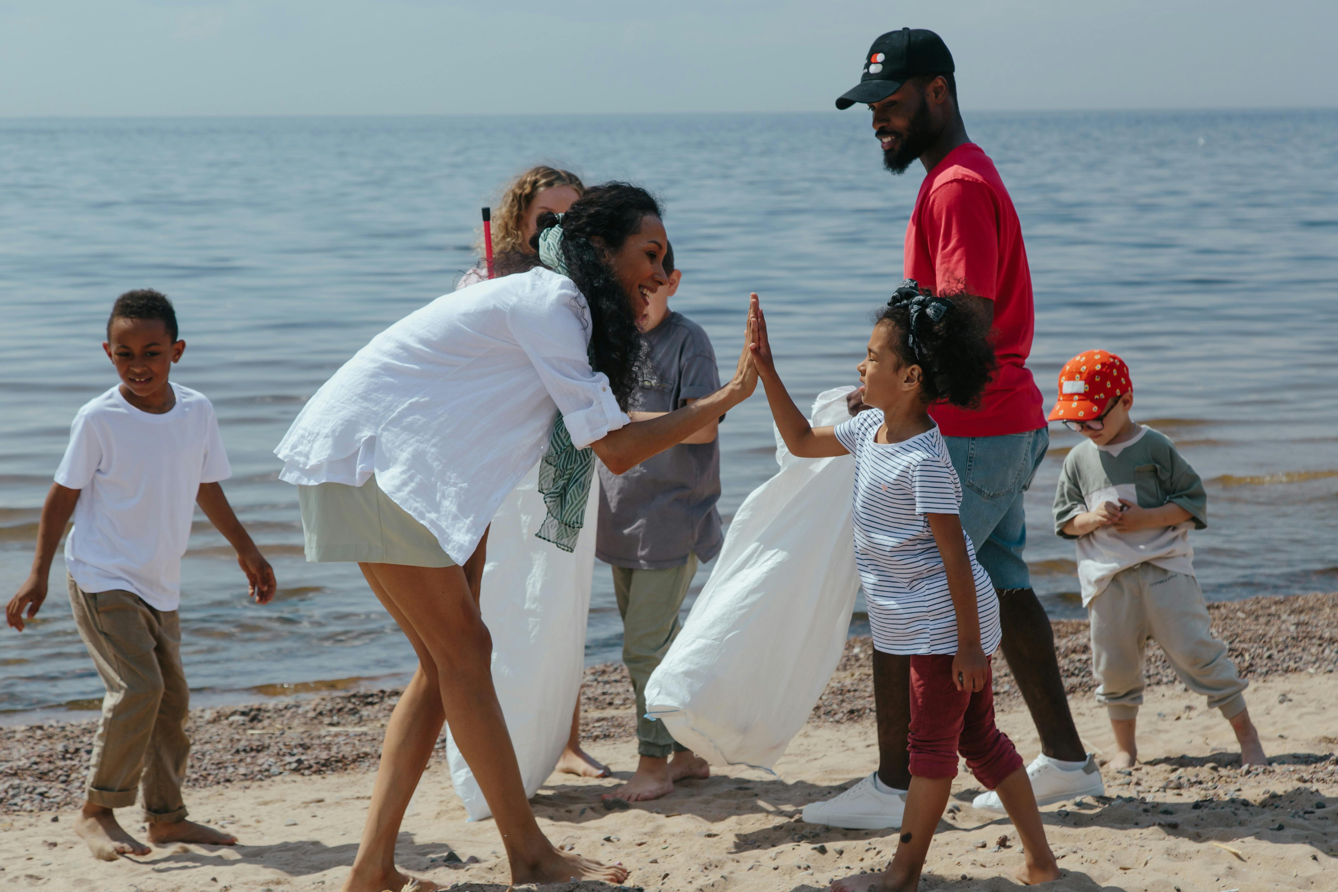 A Woman and Girl Doing High Five - Photo by Ron Lach